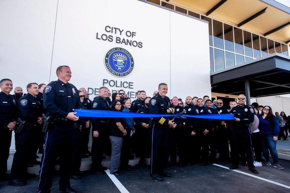 Outgoing Police Chief Gary Brizzee, center, cuts the ribbon during a grand opening ceremony and unveiling of the new Los Banos Police Department headquarters located at 1111 G Street in Los Banos, Calf., on Friday, Nov. 3, 2023. In a separate ceremony Friday afternoon, Ray Reyna was sworn in as the new Los Banos Police Chief.