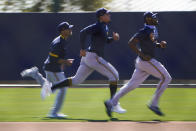 Milwaukee Brewers players, from left Corey Ray, Avisail Garcia and Lorenzo Cain runs across the field during the team's spring training baseball workout in Phoenix , Tuesday, Feb. 23, 2021. (AP Photo/Jae C. Hong)