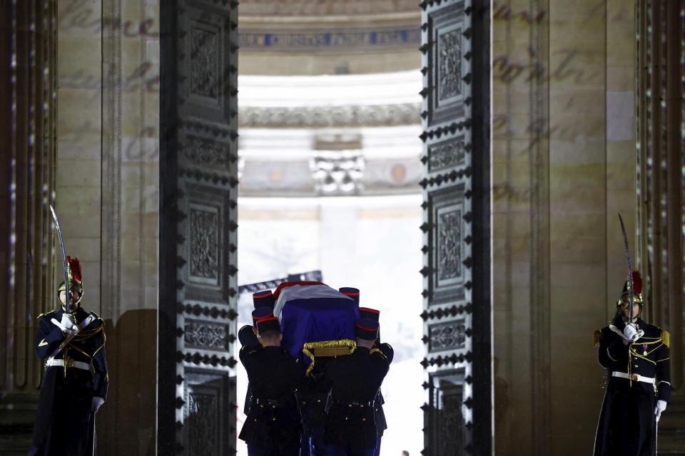 The coffin of Missak Manouchian, carried by Republican Guards, enters the Pantheon monument during his induction ceremony and his 23 resistance fighters, Wednesday, Feb 21, 2024 in Paris. A poet and communist fighter who took refuge in France after surviving the Armenian genocide, Manouchian was executed in 1944 for leading the resistance to Nazi occupation. (Sarah Meyssonnier/Pool via AP)