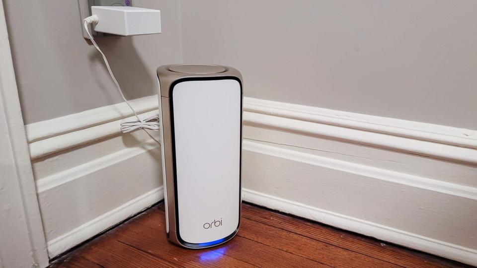 Netgear Orbi RBE973 sitting on floor