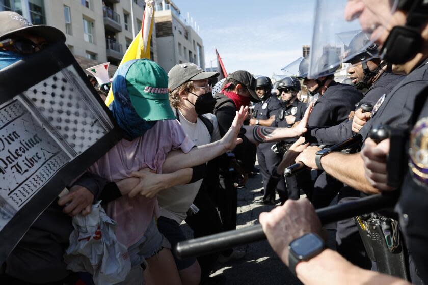 Police pushing back protesters who tried to block Oscar goers from the checkpoint entry.