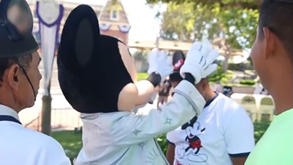 A screengrab from one of Jesús Morales' TikToks shows Mickey Mouse placing ears on a worker visiting the theme park. - Courtesy Jesús Morales