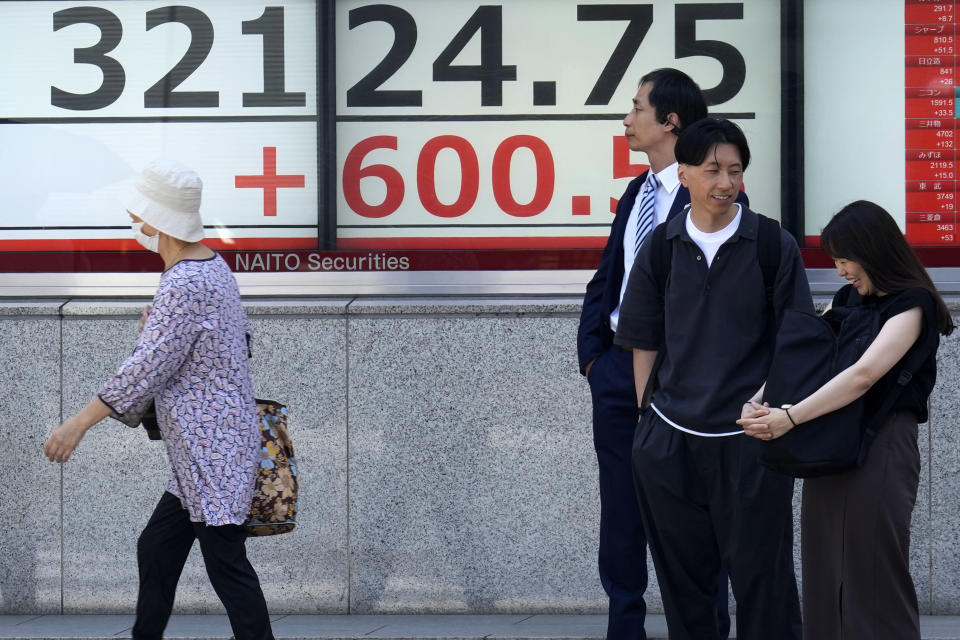 People stand in front of an electronic stock board showing Japan's Nikkei 225 index at a securities firm Monday, June 5, 2023, in Tokyo. Asian stocks followed Wall Street higher on Monday after strong U.S. hiring data coupled with scant wage gains suggested a possible recession might be further away, but also that inflationary pressures are weakening. (AP Photo/Eugene Hoshiko)