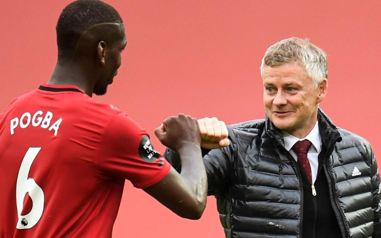 Ole Gunnar Solskjaer fist bumps Paul Pogba - GETTY IMAGES