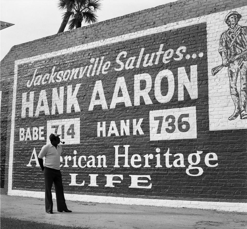 Tommie Aaron, who played and coached in the major league as well, stands in front of a sign honoring his brother Hank at Jacksonville's Wolfson Baseball Park in 1975.