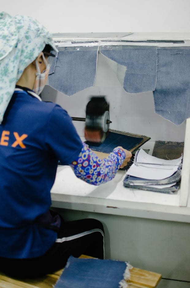 A Saitex employee individually distressing pieces of fabric that will become pockets. Photo: Whitney Bauck/Fashionista