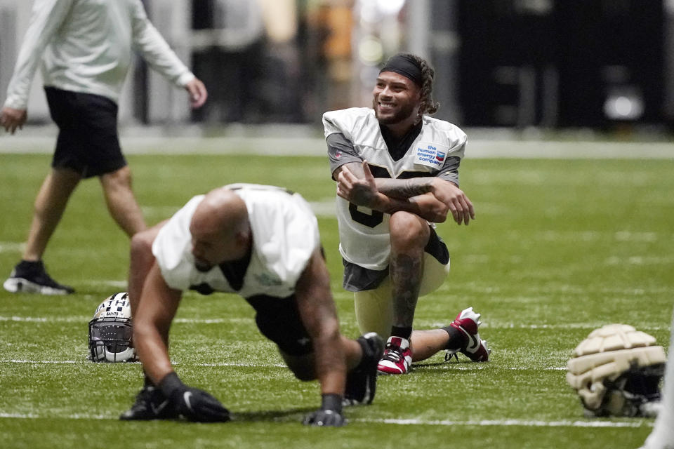 New Orleans Saints cornerback Tyrann Mathieu (32) smiles while stretching during training camp at the team's NFL football training facility in Metairie, La., Wednesday, Aug. 3, 2022. (AP Photo/Gerald Herbert)