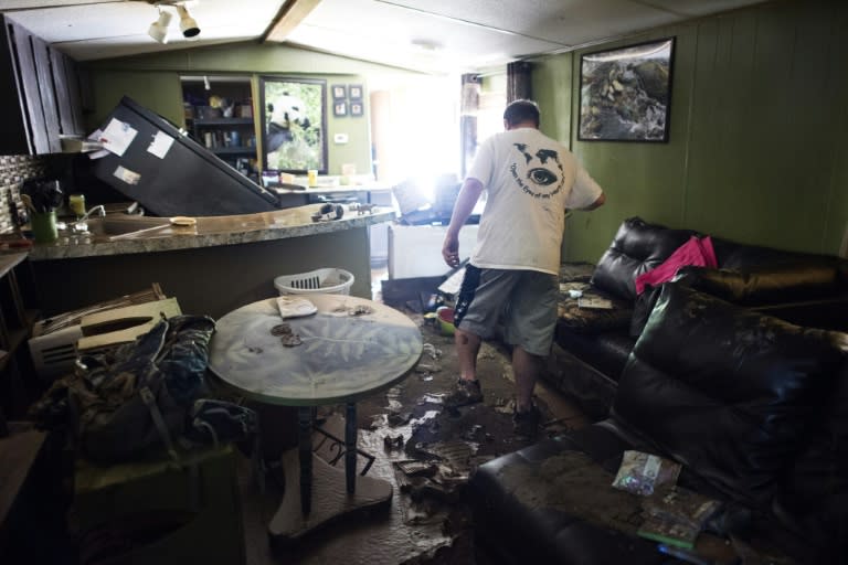 Larry Brooks walks through his trailer which was destroyed by flood waters in Elkview, West Virginia