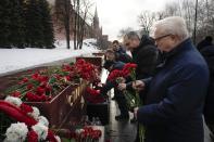 People lay flowers at the Tomb Stalingrad during a wreath-laying ceremony at the Tomb of the Unknown Soldier near the Kremlin Wall attending commemorations marking the 80th anniversary of the Soviet victory in the battle of Stalingrad in Moscow, Russia, Thursday, Feb. 2, 2023. The battle of Stalingrad turned the tide of World War II and is regarded as the bloodiest battle in history, with the death toll for soldiers and civilians estimated at about 2 millions. (AP Photo/Alexander Zemlianichenko)