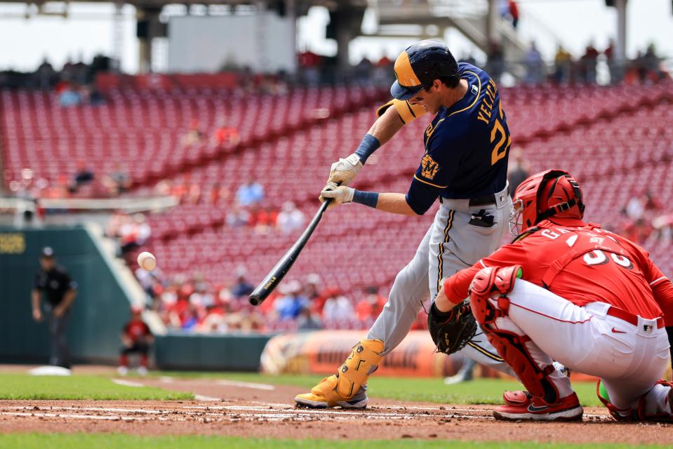 Milwaukee Brewers' Christian Yelich hits a ground-rule double during the first inning against the Cincinnati Reds.