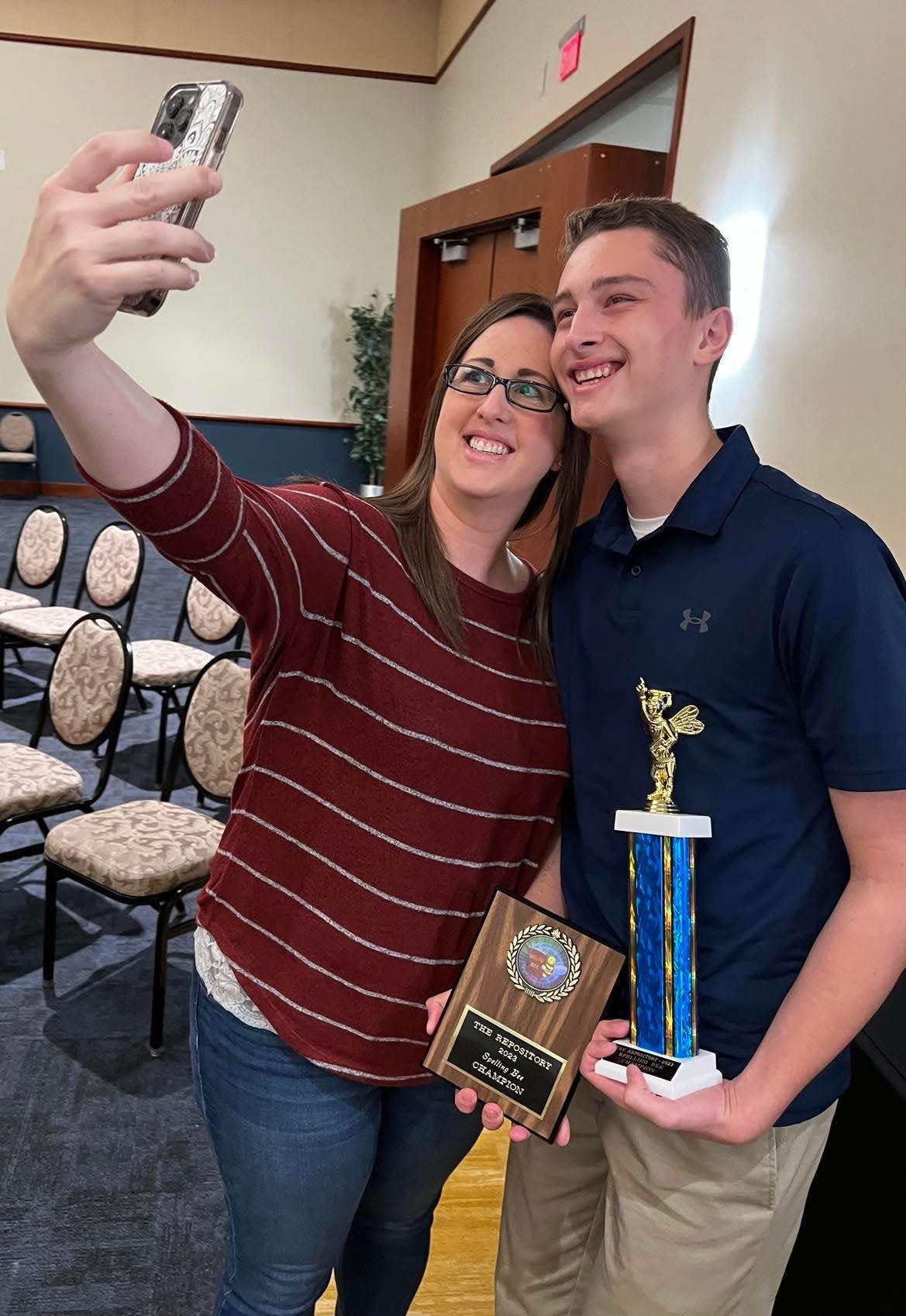 Bryce Beckley, 14, of Dover Middle School, takes a photo with his mother, Lyndy Beckley, after he won The Canton Repository's 77th Regional Final Spelling Bee on Saturday at Kent State University at Stark's Conference Center.