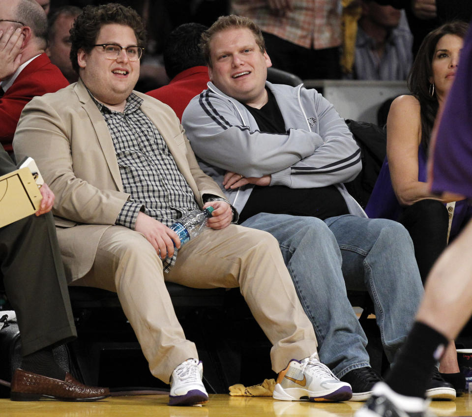 Jonah Hill, left, and a friend watch the Los Angeles Lakers play the Phoenix Suns during the first half of Game 5 of the NBA basketball Western Conference finals Thursday, May 27, 2010, in Los Angeles. (AP Photo/Chris Carlson)