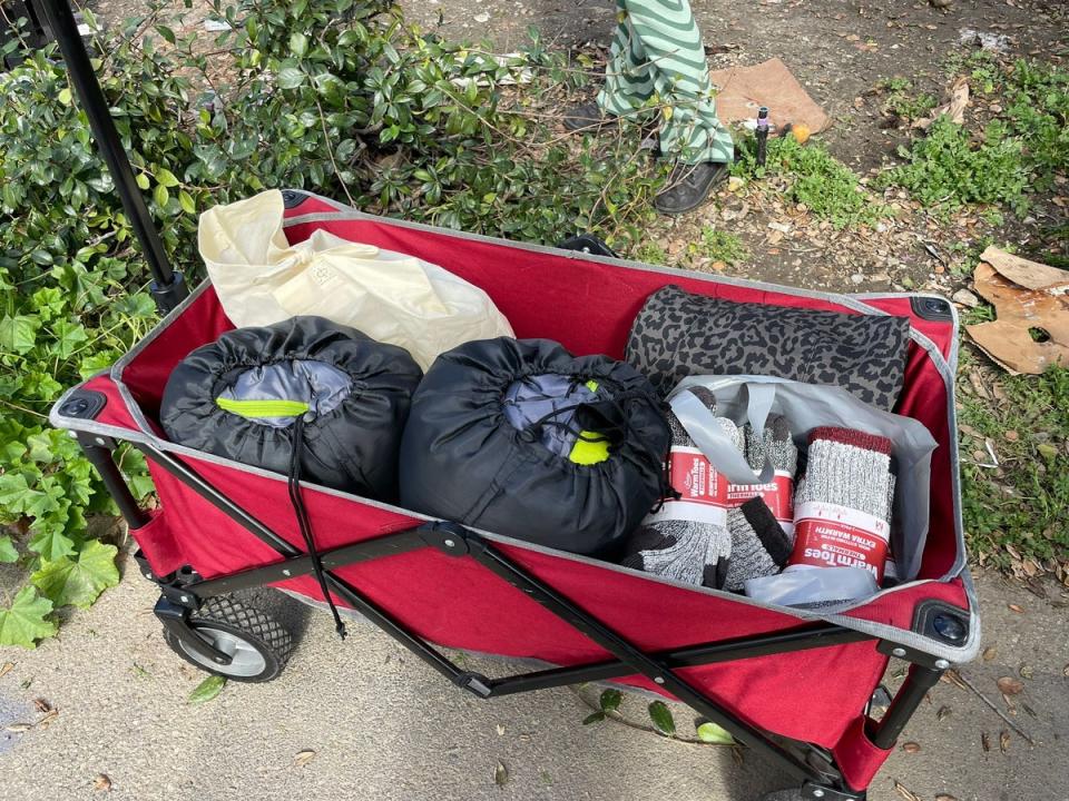 Supplies of batteries, sleeping bags and socks are distributed to people on the streets (Mike Bedigan/ The Independent)