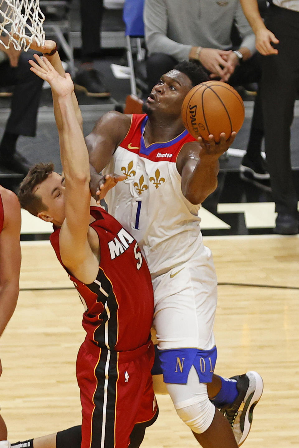 New Orleans Pelicans forward Zion Williamson (1) drives to the basket against Miami Heat forward Duncan Robinson (55) during the first half of an NBA basketball game, Friday, Dec. 25, 2020, in Miami. (AP Photo/Joel Auerbach)