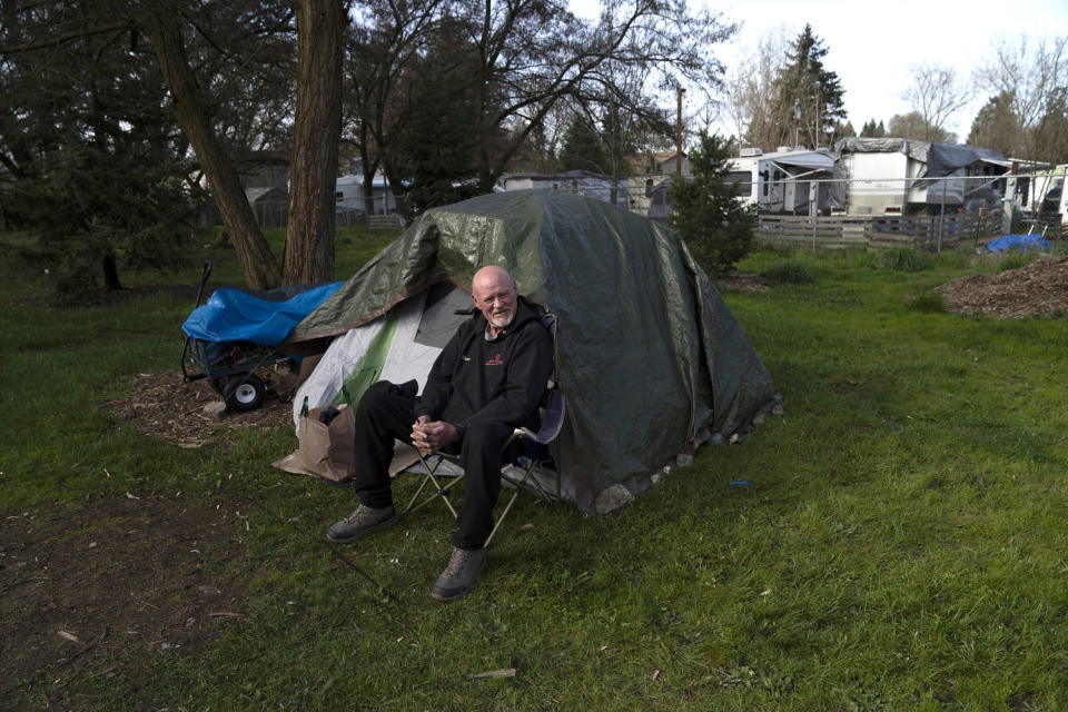 David Wilson sits outside his tent at Riverside Park in Grants Pass, Ore. (Jenny Kane / AP file )