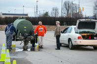 South Charleston Public Works employees assist local residents in South Charleston, W.V. in obtaining bottled water at the GeStamp Stamping Plant-South Charleston (W.Va.) distribution location Sunday morning, Jan. 12, 2014. This location will remain open 24-hours a day until the ban on using tap water for drinking and washing is lifted. The ban has been in effect following the chemical spill Thursday in the Elk River that has contaminated the public water supply in nine counties.. (AP Photo Michael Switzer)