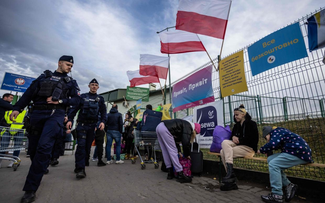 Refugees from Ukraine rest at the border crossing in Medyka, Poland, on Thursday - Wojtek Radwanski/AFP via Getty Images