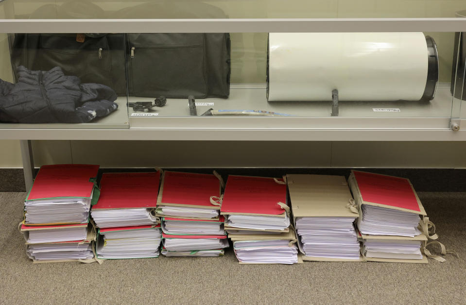 Pieces of evidence and court documents are displayed in a case during the start of the trial for the Brussels attacks, that took place on March 22, 2016, at the Justitia building in Brussels, Monday, Dec. 5, 2022. More than six years later, ten defendants face charges including murder, attempted murder and membership, or participation in the acts of a terrorist group, over the morning rush hour attacks at Belgium's main airport and on the central commuter line on March, 22, 2016. (AP Photo/Olivier Matthys, Pool)