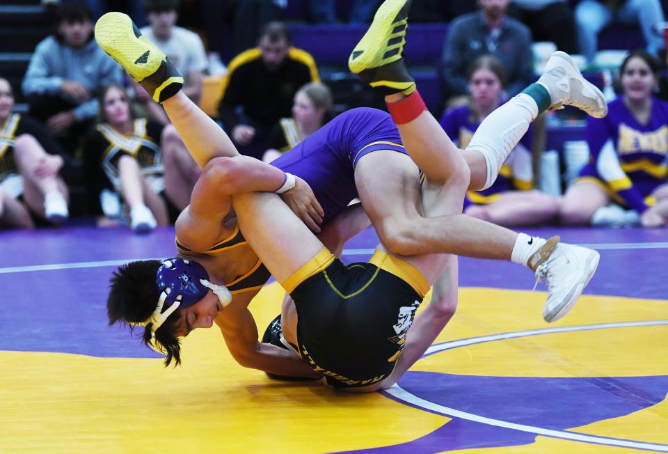 Nevada's Kaden Weber takes down West Marshall's Shane Hanford on his way to a 7-2 victory in the championship match at 106 pounds during the HOIC wrestling meet Friday in Nevada.