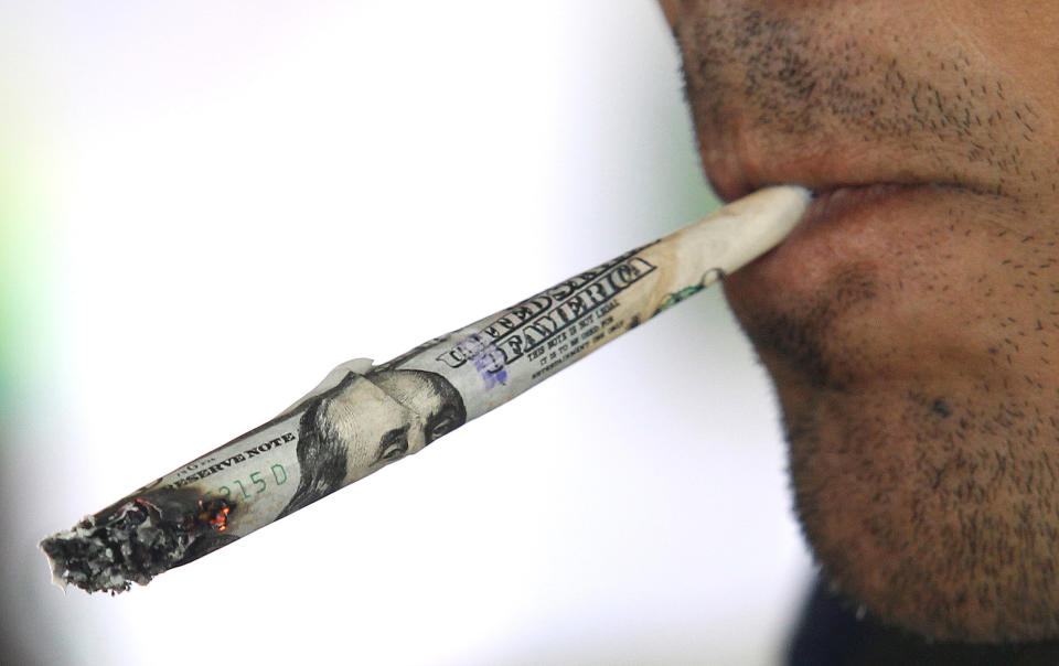 A visitor smokes a joint during the first Cannabis Cup where self-cultivation and the quality of the herb are encouraged, in Tlajomulco de Zuniga, Jalisco State, Mexico, on March 18, 2018. ULISES RUIZ/AFP/Getty Images)