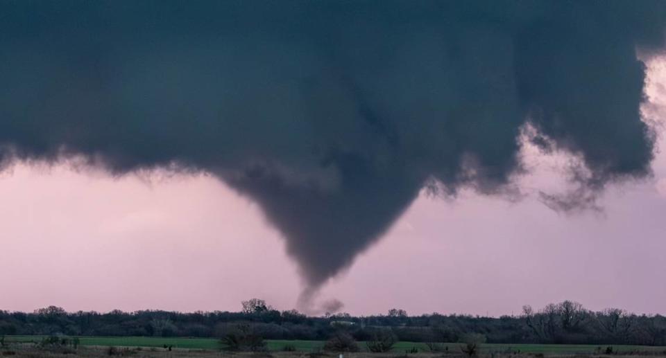 A tornado, illuminated by lightning, forms near Alta Vista in March. The storm mostly stayed over open country. Tornadoes have happened around Wichita this spring, but not in the city even though some predictions have said they were likely.