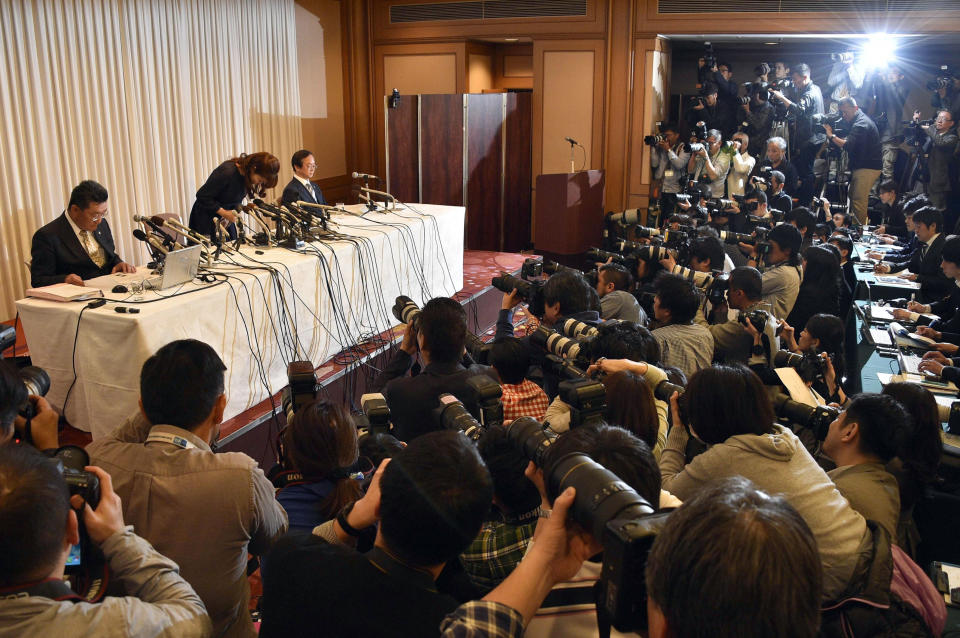 Haruko Obokata, center on stage, a researcher of Japanese government-funded laboratory Riken Center for Development Biology, bows in apology at the beginning of a press conference at a hotel in Osaka, western Japan Wednesday, April 9, 2014. The scientist accused of falsifying data in a widely heralded stem-cell research paper said that despite mistakes in her work the results are valid. (AP Photo/Kyodo News) JAPAN OUT, MANDATORY CREDIT