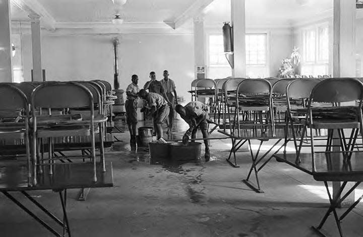 Students mop the floors of the dining hall at the Alabama Industrial School for Negro Children in this 1965 photo by Haywood Paravicini.
