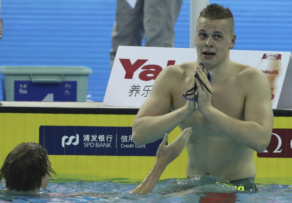 Gold medalist Lithuania's Danas Rapsys, right, gestures after winning the men's 400m freestyle finals at the 14th FINA World Swimming Championships in Hangzhou, China on Tuesday Dec. 11, 2018. (AP Photo/Ng Han Guan)