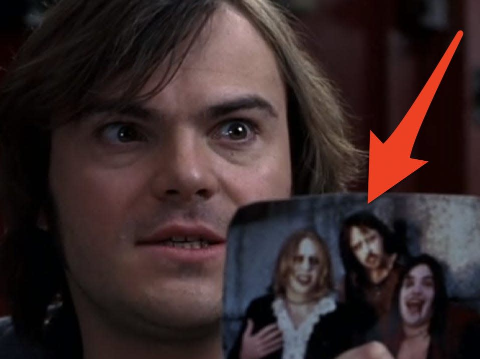 Dewey holding up a photo of his old band.