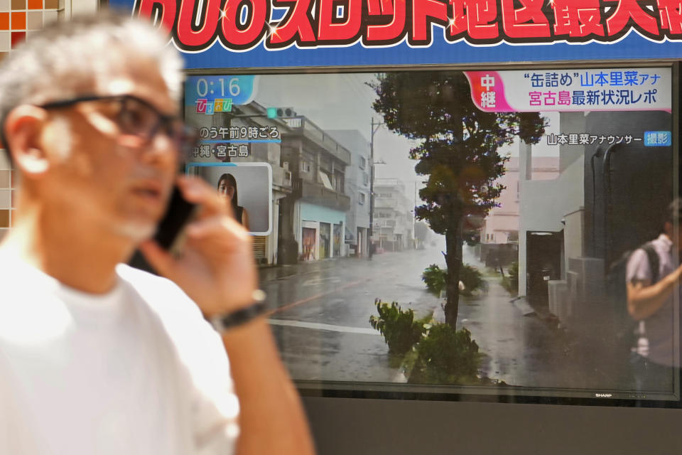 A tv screen shows news report on the approaching typhoon, in Tokyo, Japan, Friday, Aug. 4, 2023. Residents of Japan's southwestern islands were warned of high winds and rain through the weekend once a nearly stationary Typhoon Khanun starts moving east later Friday. (AP Photo/Shuji Kajiyama)