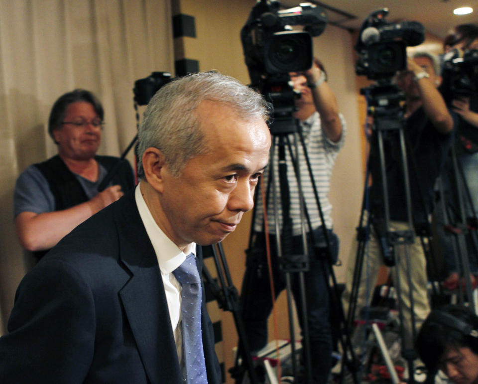 Tokyo Electric Power Co. President Naomi Hirose arrives at the Foreign Correspondents' Club of Japan in Tokyo for a press conference Thursday, July 19, 2012. The new head of the operator of Japan's crippled nuclear plant has vowed to try to overcome deep public distrust in his company. But Hirose also says he's not ready to agree with a parliamentary panel's conclusion that cozy ties between the government and industry were to blame for last year's nuclear disaster. (AP Photo/Koji Sasahara)