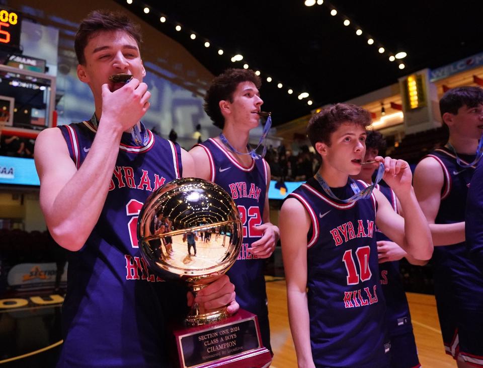 Byram Hills' Tyson Repa (2) holds the Gold Ball trophy after defeating Rye 47-44 in the Section 1 Class A boys basketball championship game at the Westchester County Center in White Plains on Saturday, March 2, 2024.