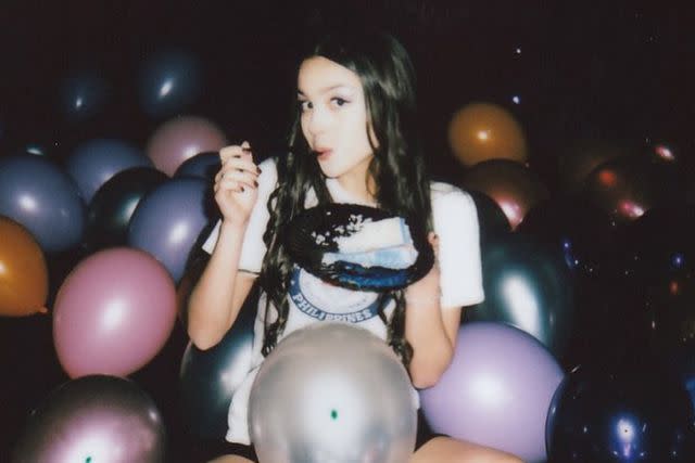 <p>Olivia Rodrigo/Instagram</p> Olivia Rodrigo with her "spill ur guts" 21st birthday cake.