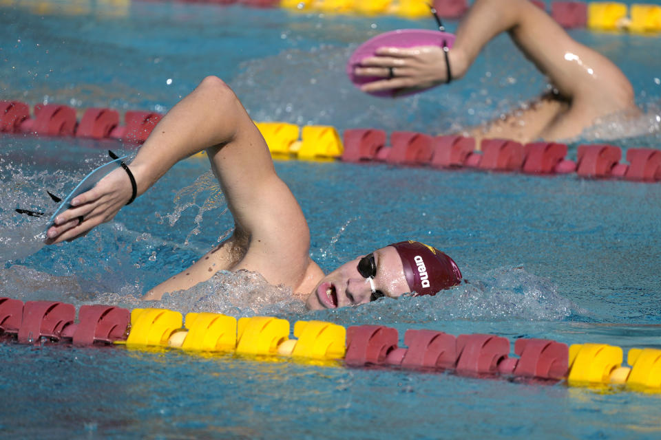 French Olympic swimmer Leon Marchand trains with his Arizona State University teammates, Tuesday, Feb. 13, 2024, in Tempe, Ariz. With family and friends — an entire nation — watching, the individual medley specialist is poised to be one of the premier faces of these Olympics. (AP Photo/Ross D. Franklin)