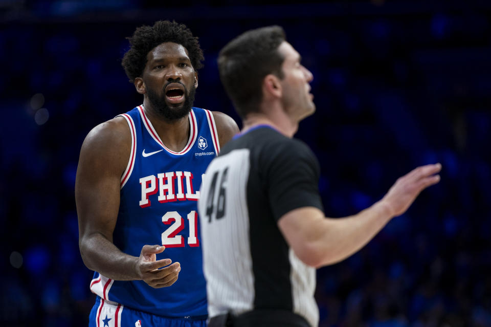 Philadelphia 76ers' Joel Embiid, left reacts to the call by official Ben Taylor, right, during the first half of an NBA basketball game against the Portland Trail Blazers, Sunday, Oct. 29, 2023, in Philadelphia. (AP Photo/Chris Szagola)