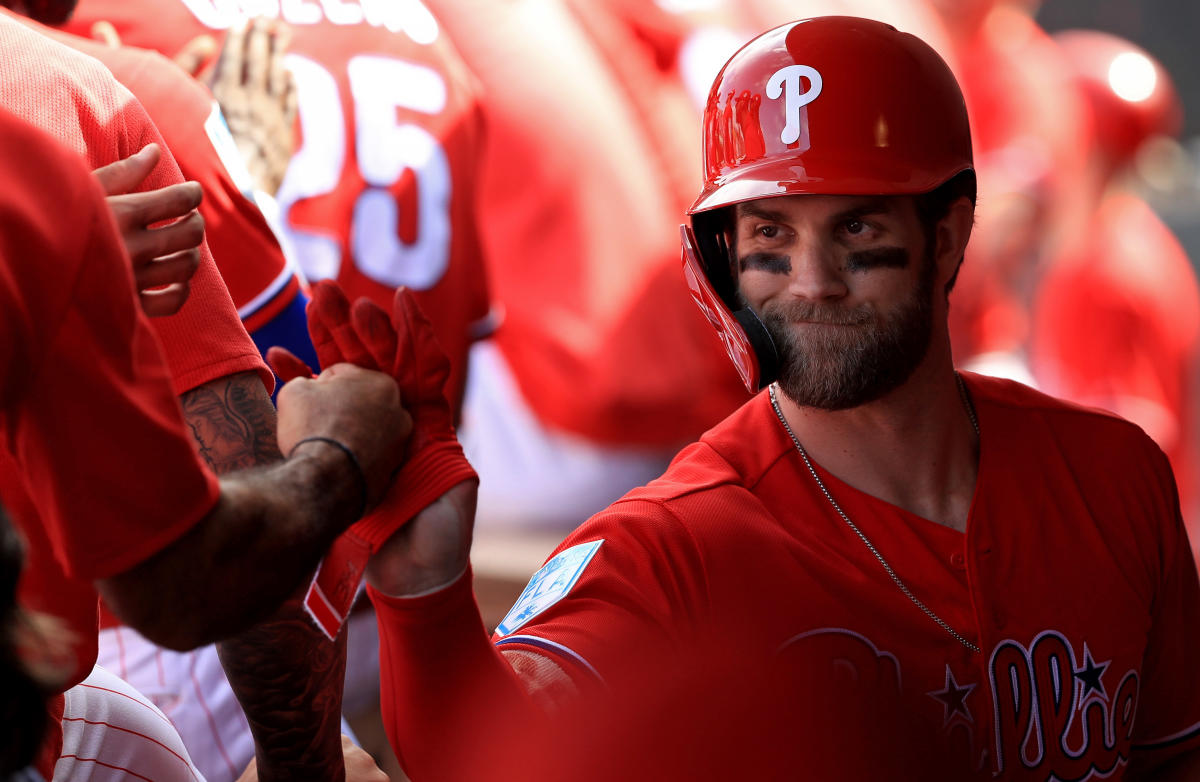 Phillies' Bryce Harper Signs His Helmet for a Young Fan After