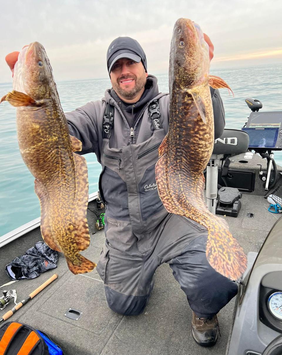 Scott Skafar of Valparaiso shows off the record-breaking burbot he caught in Lake Michigan in Porter County on Dec. 30, 2022.