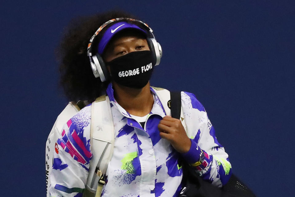 Naomi Osaka walks on court wearing a mask with the name of George Floyd on it before her quarterfinal match at the U.S. Open on Sept. 8, 2020. (Photo by Matthew Stockman/Getty Images )