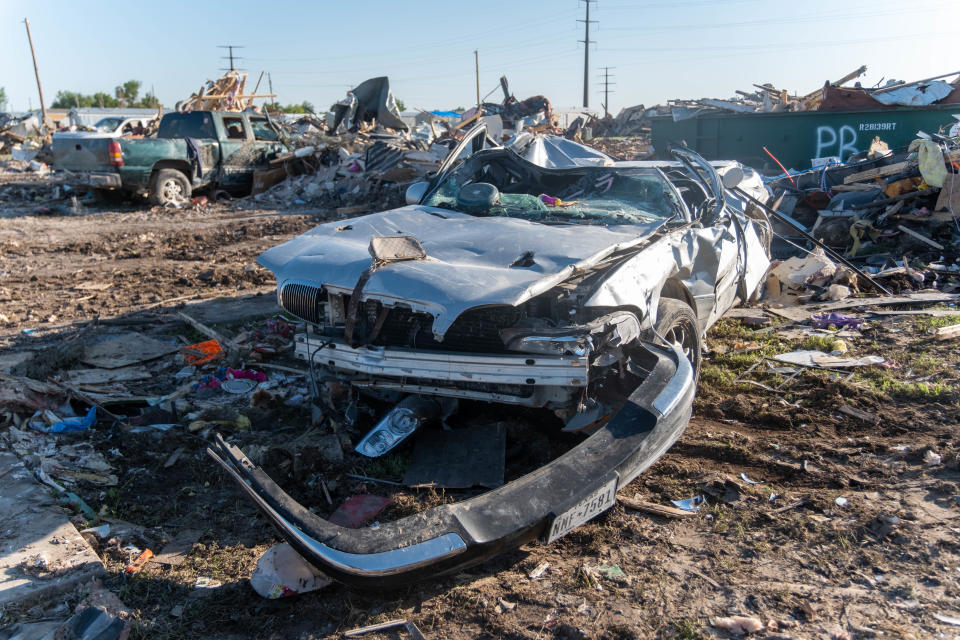 Multiple destroyed vehicles and debris lay in the way west of downtown Perryton.