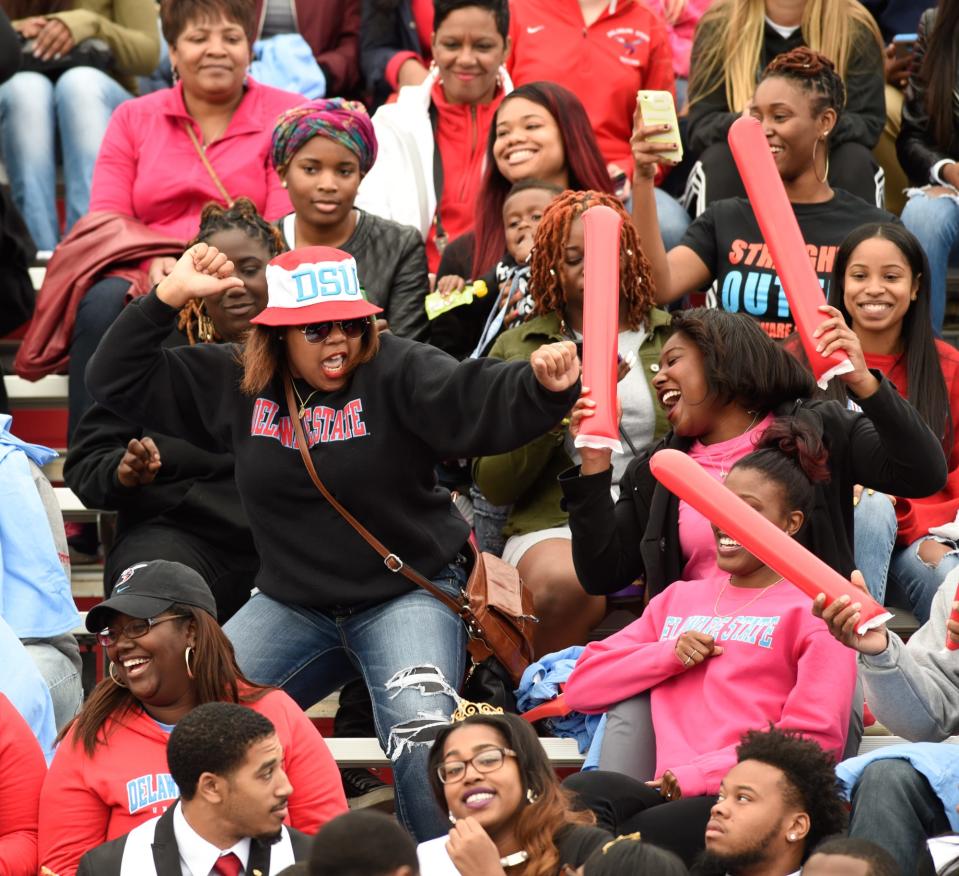 Delaware State University fans dance in the stands in their homecoming football game against South Carolina State in Dover.