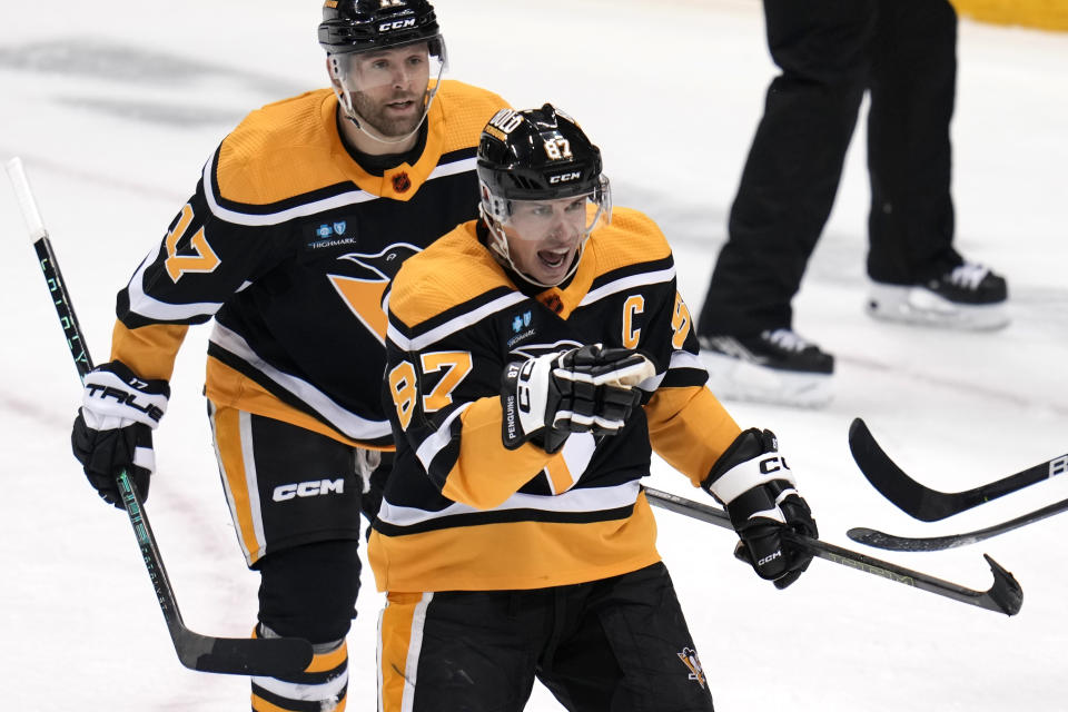 Pittsburgh Penguins' Sidney Crosby (87) celebrates his goal against the Vancouver Canucks during the first period of an NHL hockey game in Pittsburgh, Tuesday, Jan. 10, 2023. (AP Photo/Gene J. Puskar)