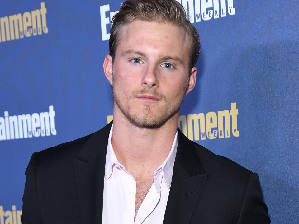 Alexander Ludwig posing at a red carpet in January 2020.