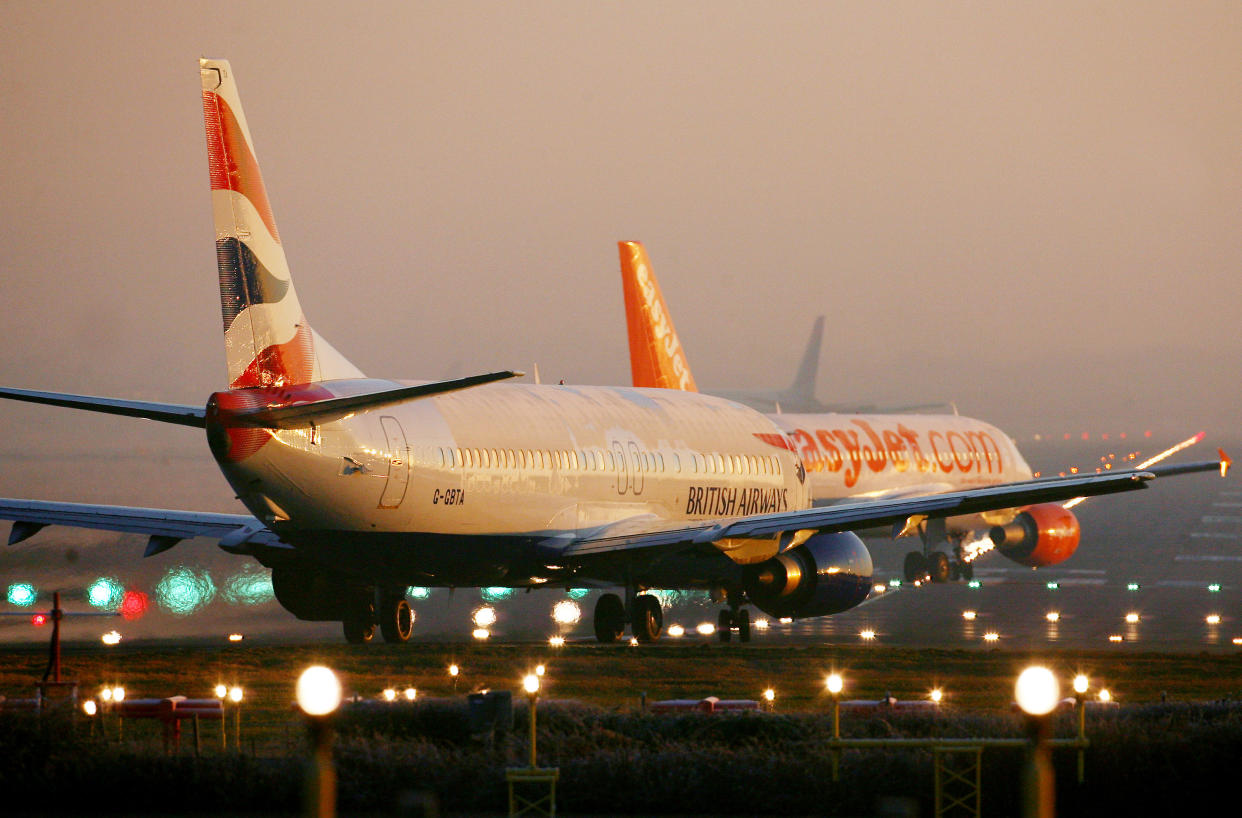 British Airways and EasyJet passenger planes prepare for an early morning take off at Gatwick Airport in West Sussex.