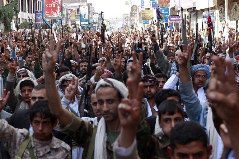 Supporters of the Shiite Huthi movement brandish their weapons as they take part in a demonstration in the capital Sanaa, on May 1, 2015