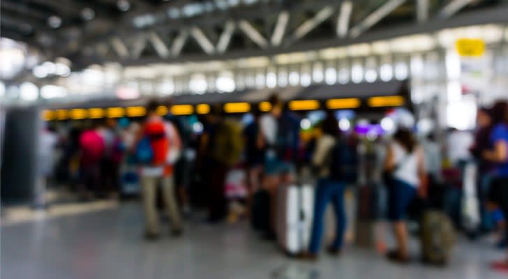 a blurry photo of people standing in line at an airport