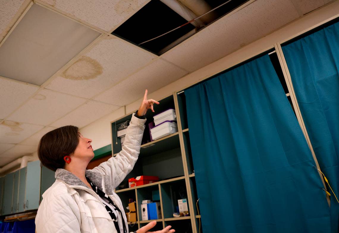 Emily Hardee, assistant principal at Brentwood Elementary School, points to ceiling damage from leaks in a classroom on Wednesday, Oct. 12, 2022, in Raleigh, N.C. Brentwood Elementary is one of seven schools that would undergo renovations in a $530.7 million bond referendum on the Nov. 8 ballot.