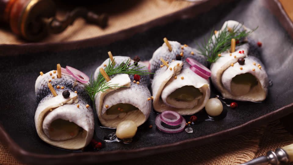 Rolled herring in vinegar, served with onions and pickles.  - gkrphoto/Shutterstock