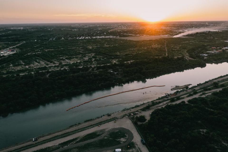 A string of buoys is deployed to prevent migrants from swimming across the Rio Grande in Eagle Pass on July 13, 2023.