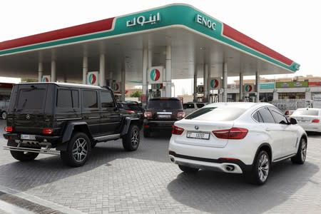 Motorists wait to fuel their vehicles with petrol at a gas station in Dubai