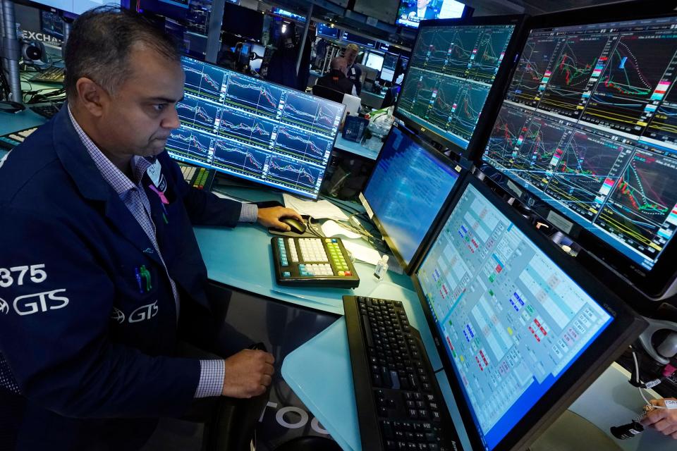 Specialist Dilip Patel works at his post on the floor of the New York Stock Exchange,